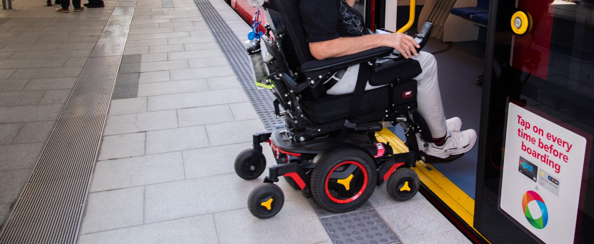 Passenger in a wheel chair boarding the Light Rail